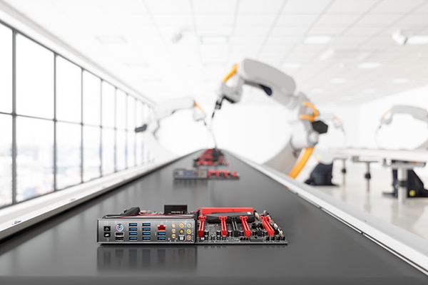 Electronics boards ride a conveyor through an assembly work cell Image of electronics boards ride a conveyor through an assembly work cell