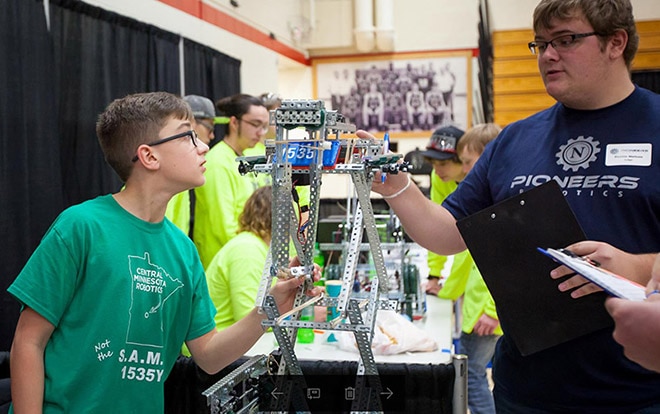 One DigiKey employee, a judging volunteer, participates in interviewing a student on the creation of their robot design