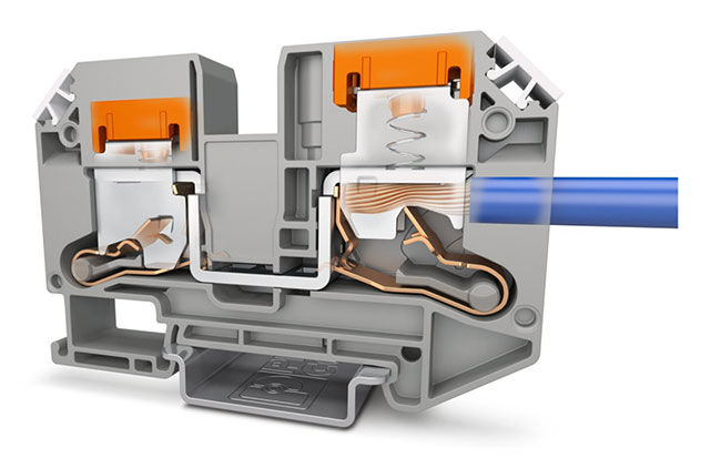 In its factory setting, the pusher is depressed, as shown on the left. The orange pusher pops up when the contact spring engages a conductor, as shown on the right