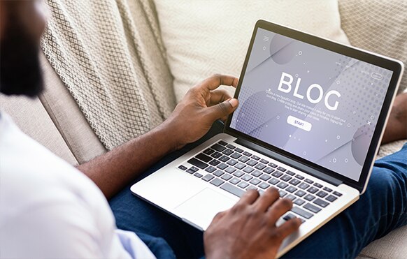 Man accessing a blog on a laptop