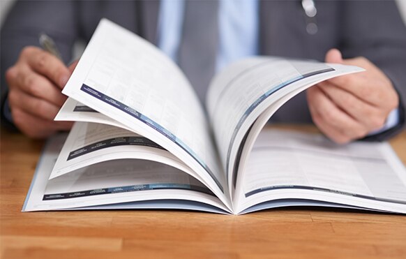 Person flipping through a technical guide