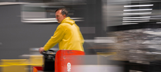 Man driving vehicle carrying pallets