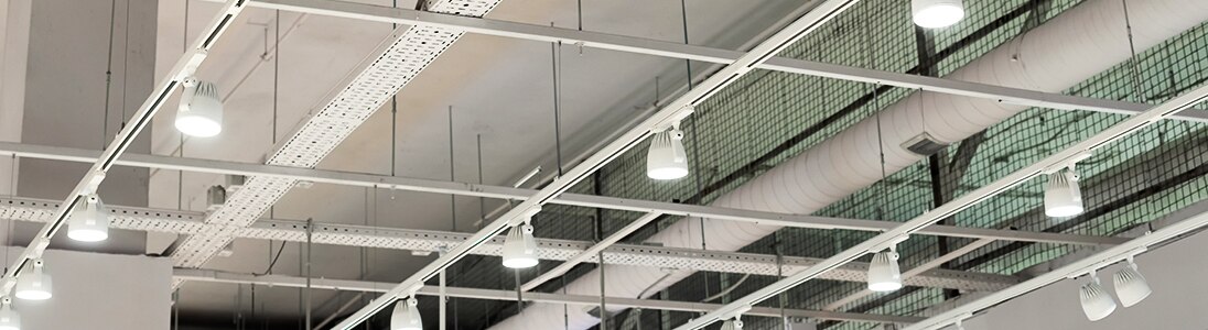 A view of a ceiling with rows of white LED lights