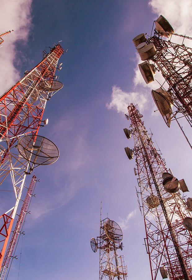 Low-angle view of numerous cell/radio towers