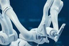 An image of two robotic arms for medical procedures against a blue background