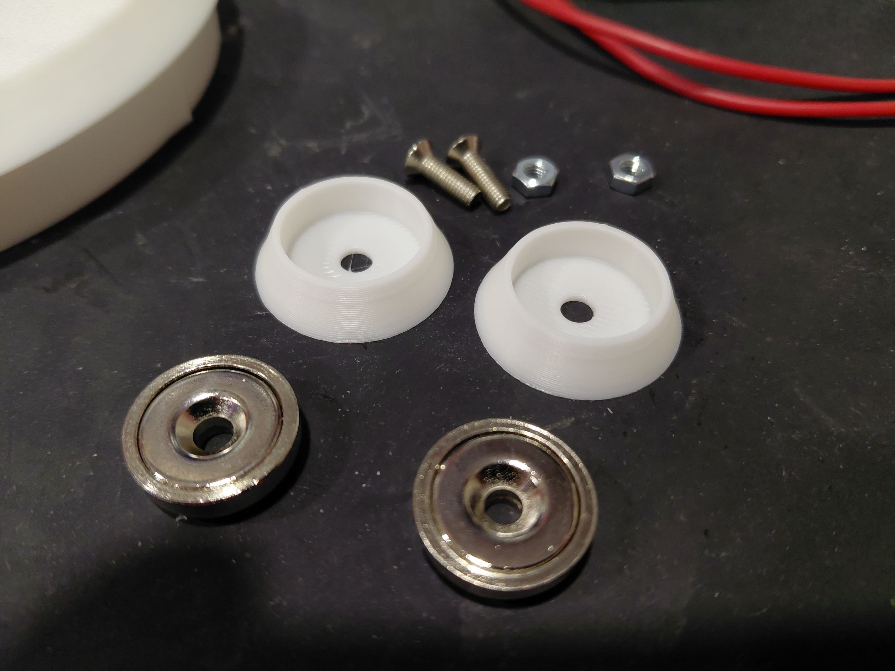 3d printed parts and magnets on table
